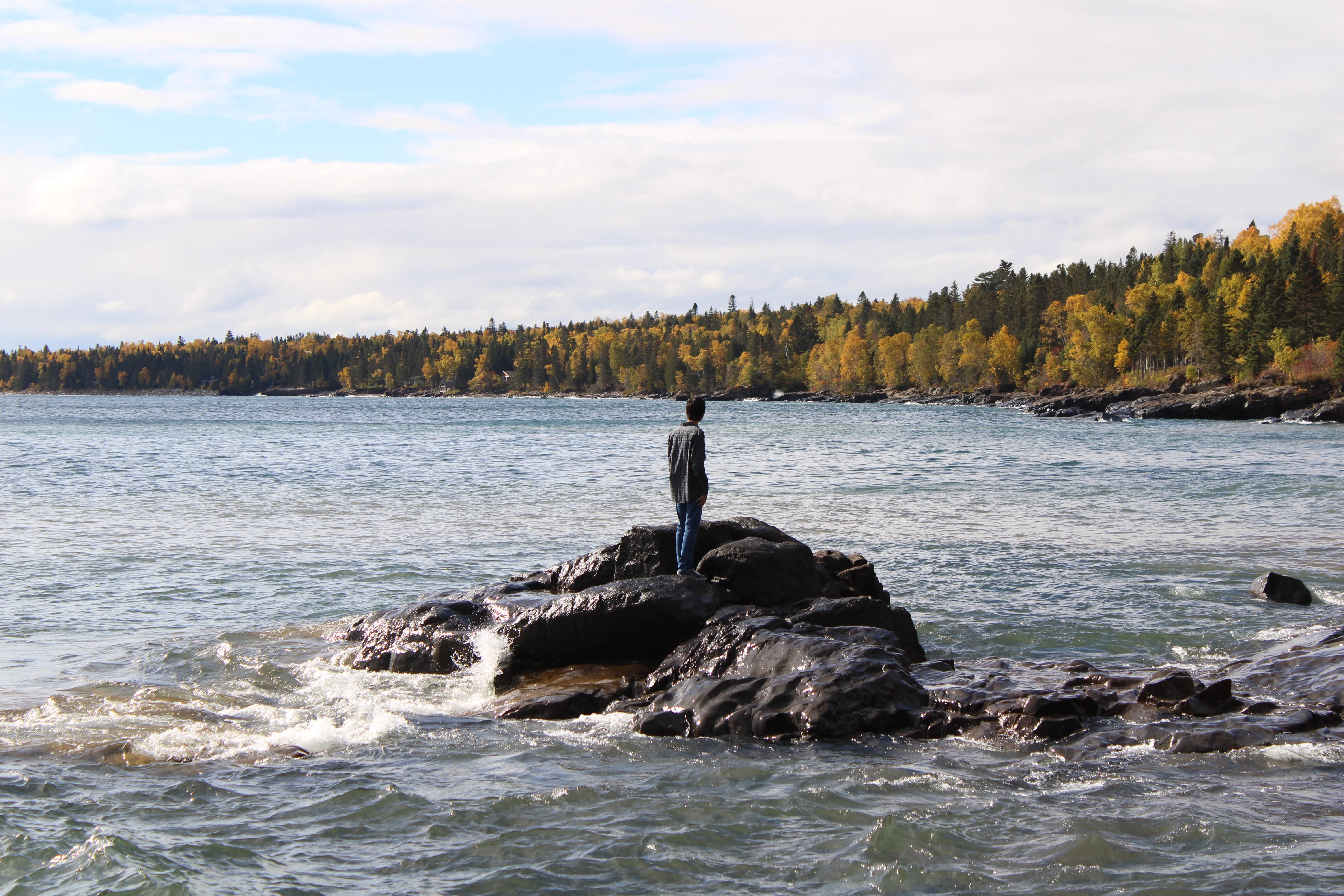 Standing on a rock outcrop looking out over Lake Superior in autumn